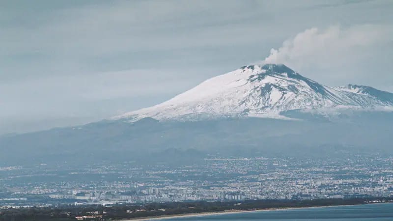 L'Etna innevato sopra Catania e il mare